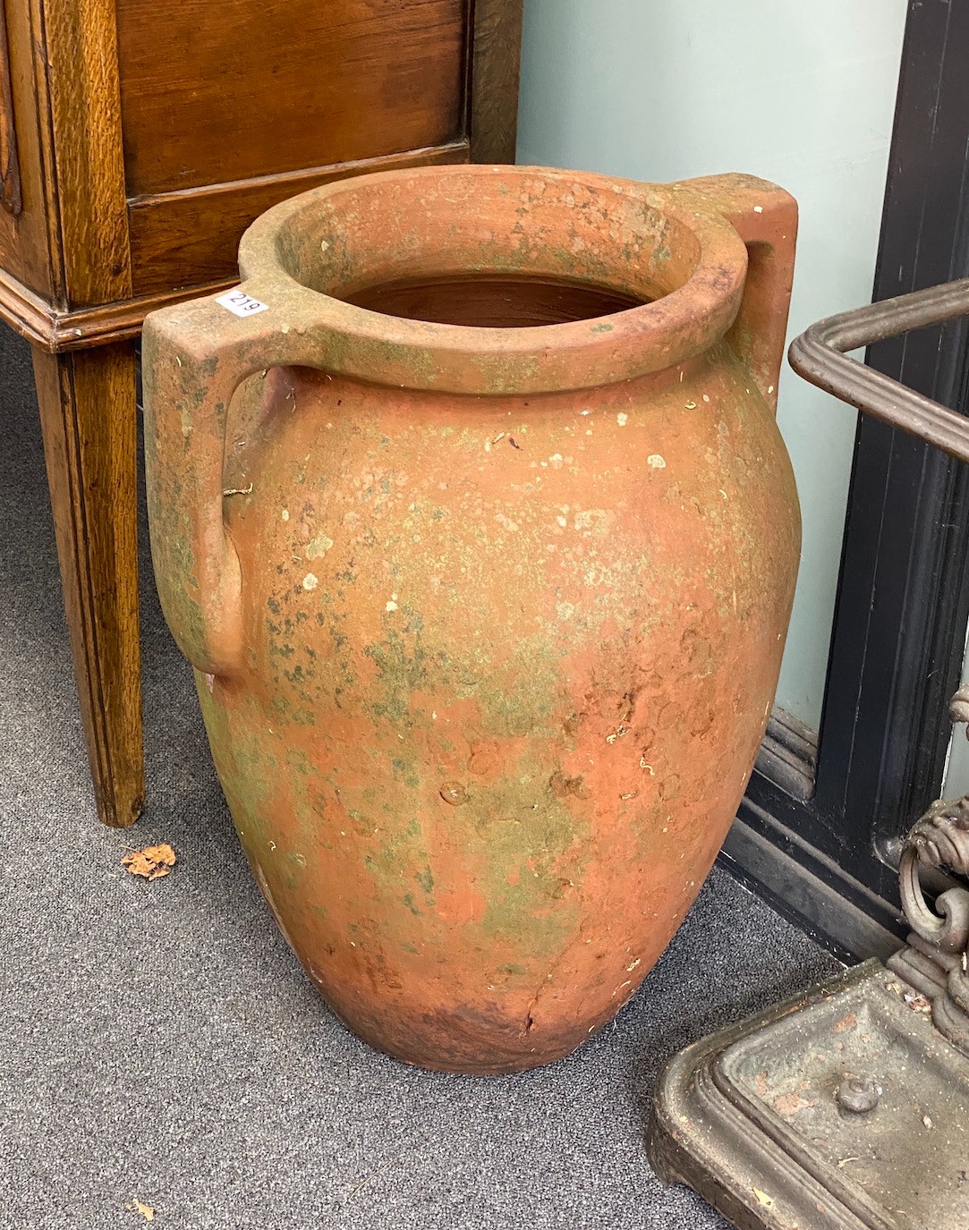 A pair of two handled terracotta amphoras, width 46cm, height 59cm